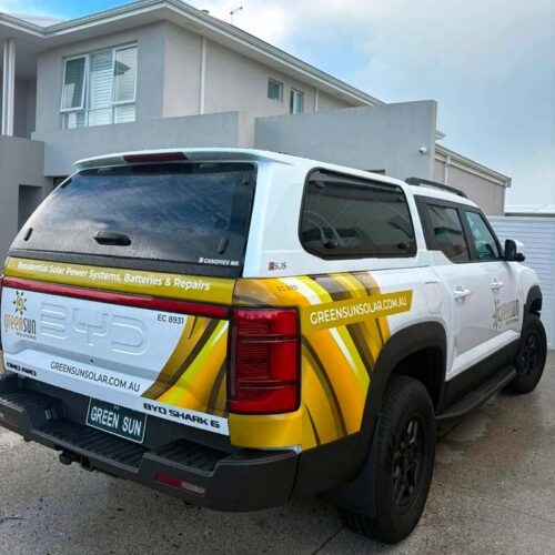 Green Sun Solutions BYD electric ute parked outside a home