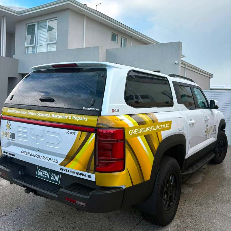 Green Sun Solutions BYD electric ute parked outside a home