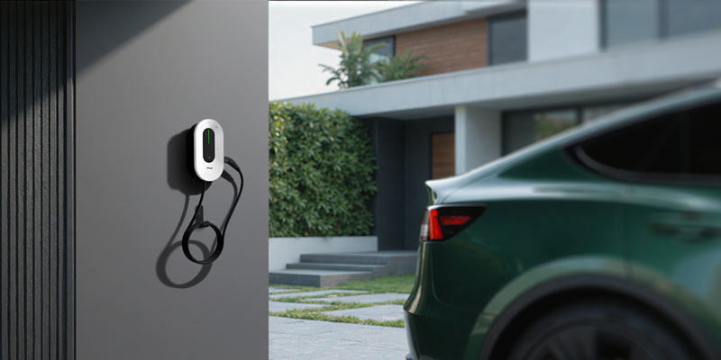 EV charger mounted on a wall beside an electric car