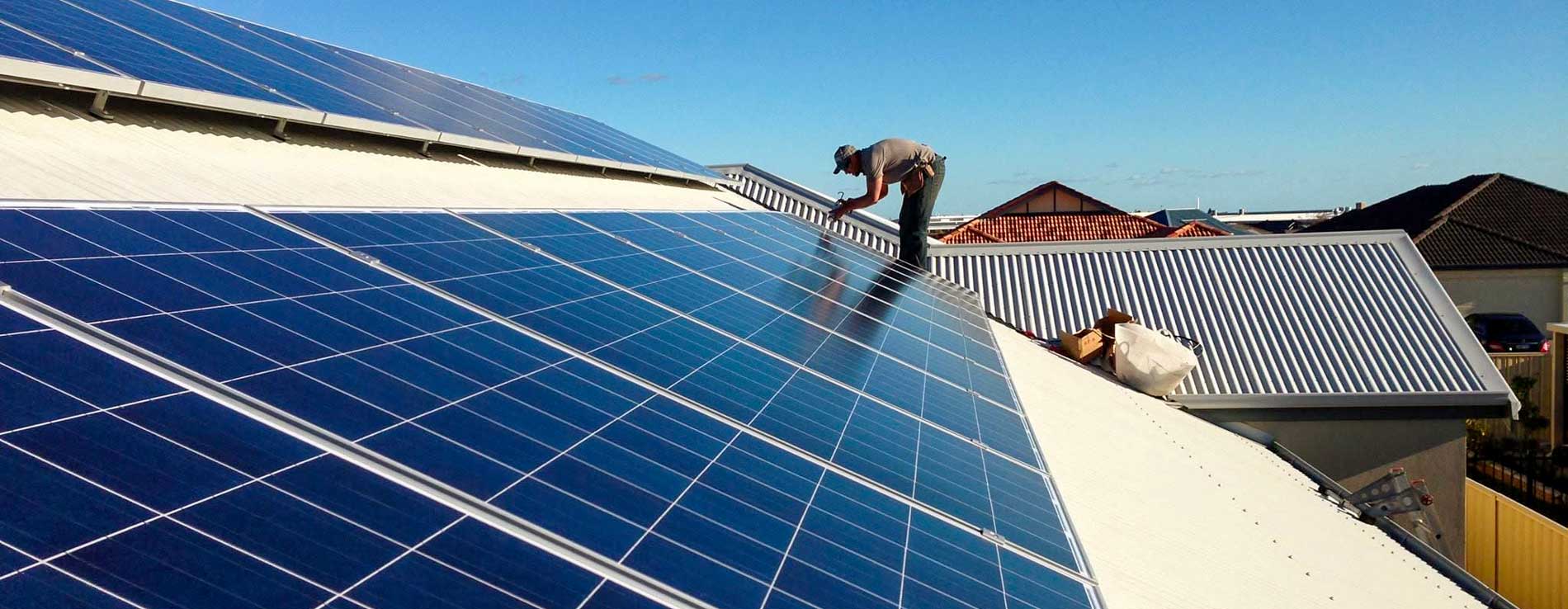 Green Sun Solutions installer fitting solar panels on a residential roof
