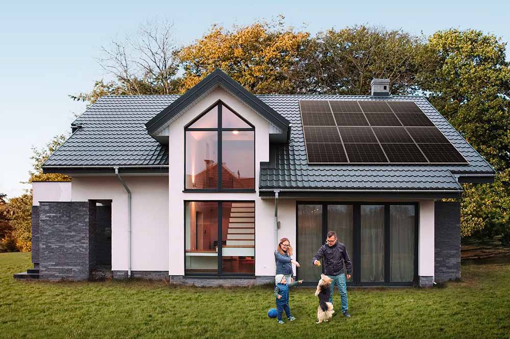 Family enjoying the outdoors near a home with solar panels