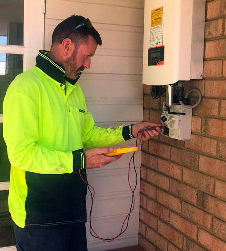 Green Sun Solutions technician testing a solar system for faults